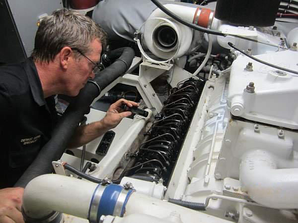 Gary A. Gillespie inspecting an engine