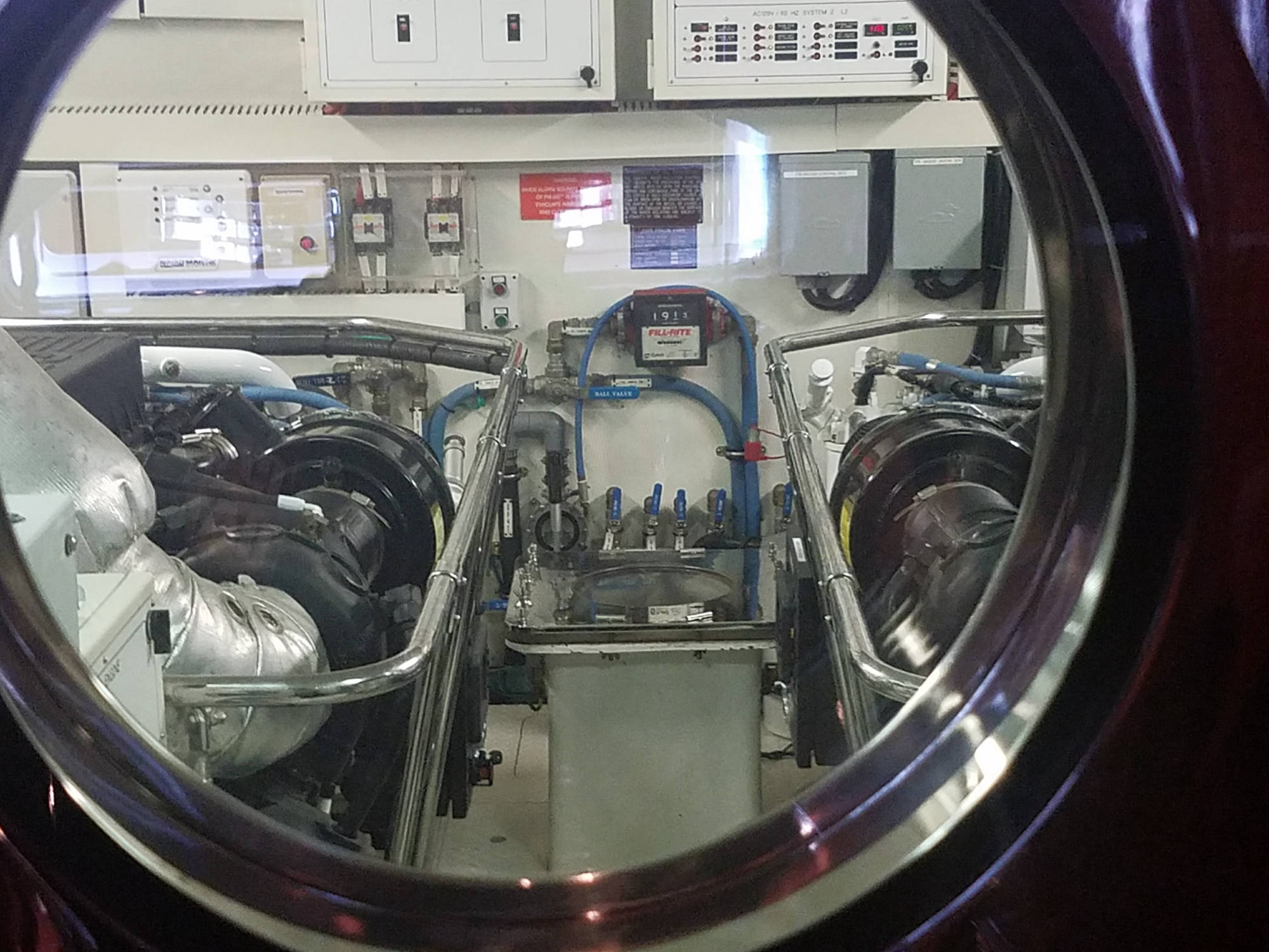 Marine engine room through a porthole window